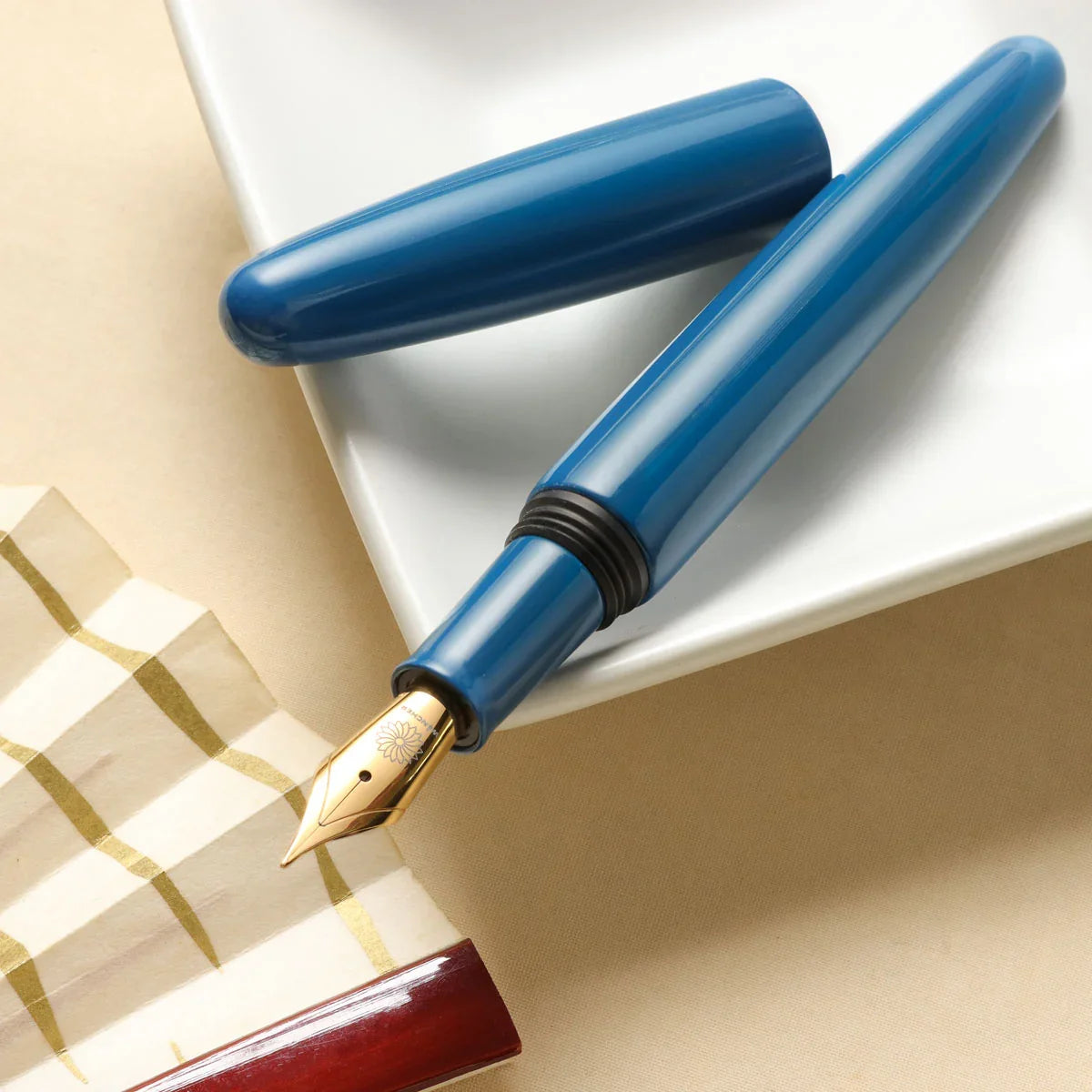 Aizu Urushi Ao fountain pen with a blue Urushi showing the gold-plated steel nib