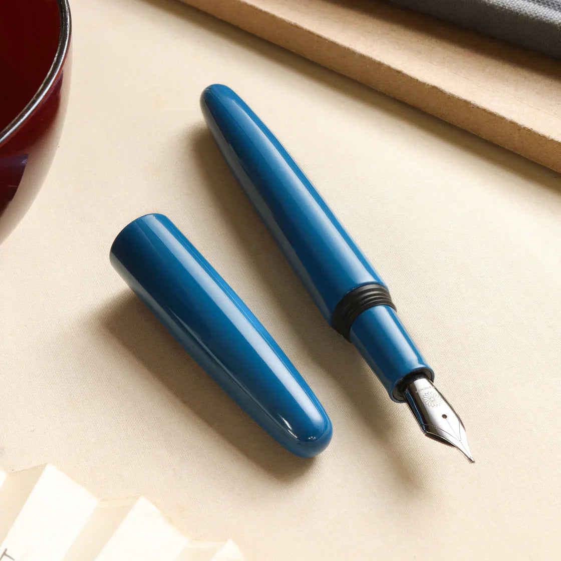 Aizu Urushi Ao fountain pen showing its nib and deep blue Urushi body.