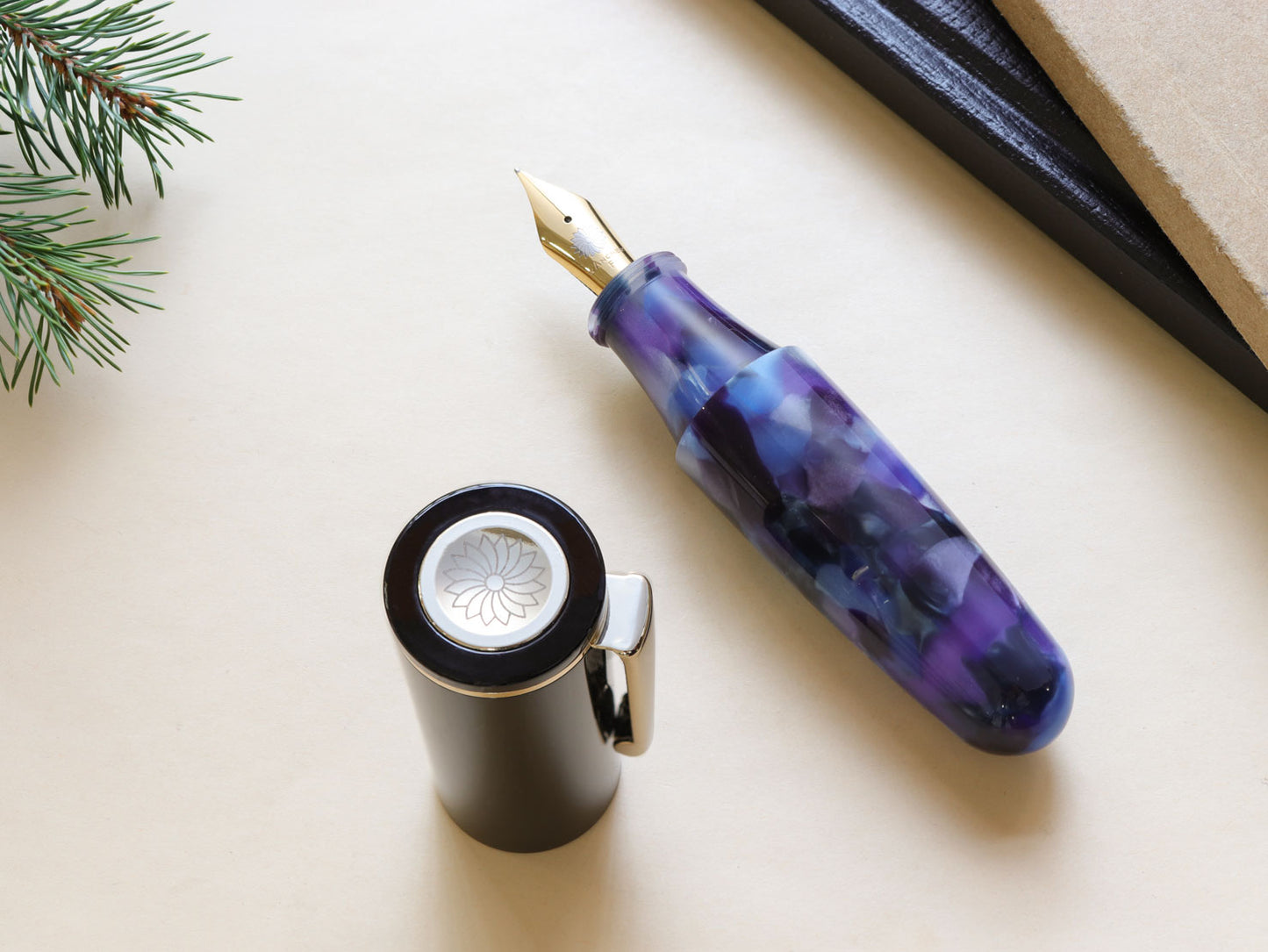 Uncapped Pochaco midnight violet with purple and black hue on top of bright background and books