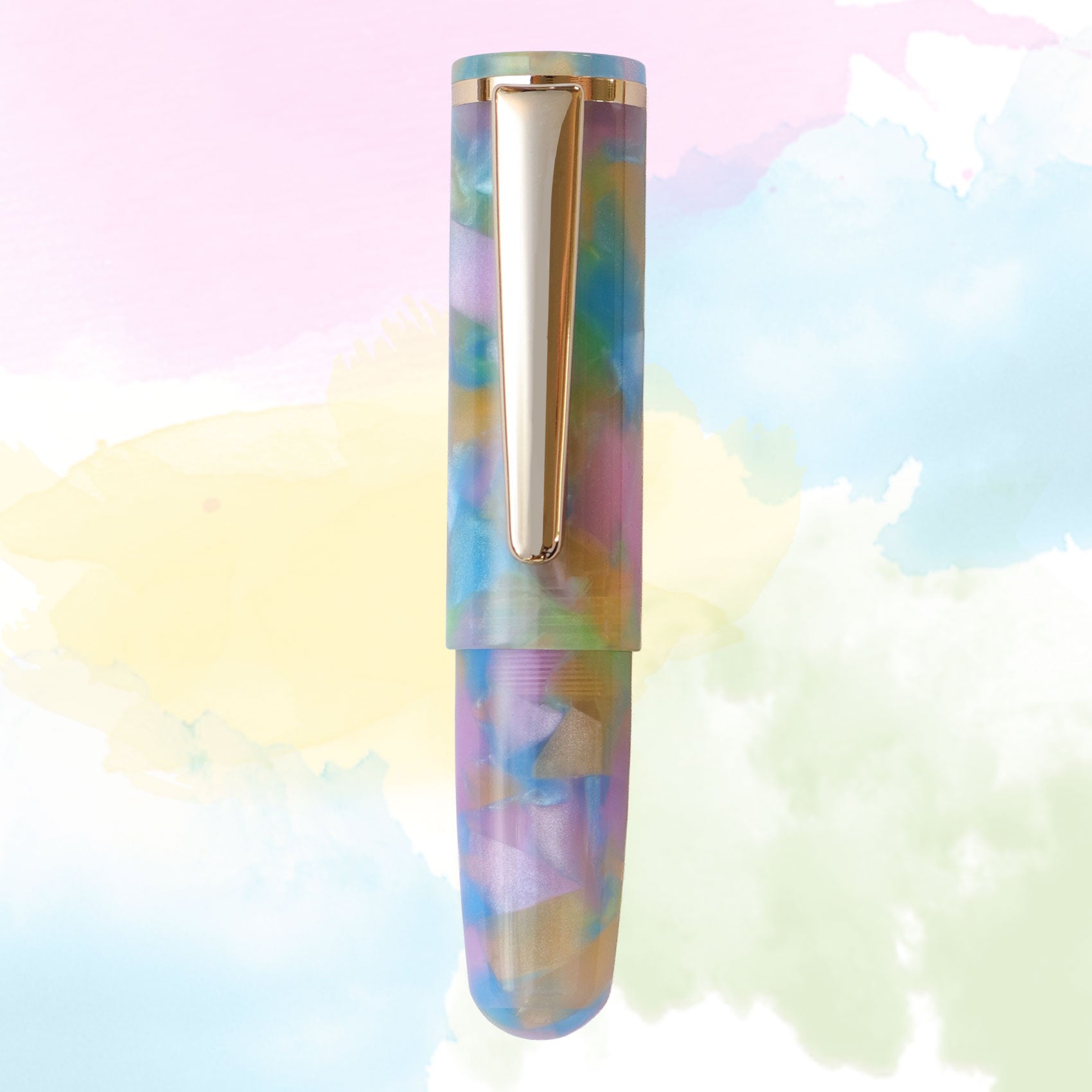 A single pen centered against a pastel watercolor background. The pen has an iridescent marbled pattern with pastel rainbow tones and gold metal clip.